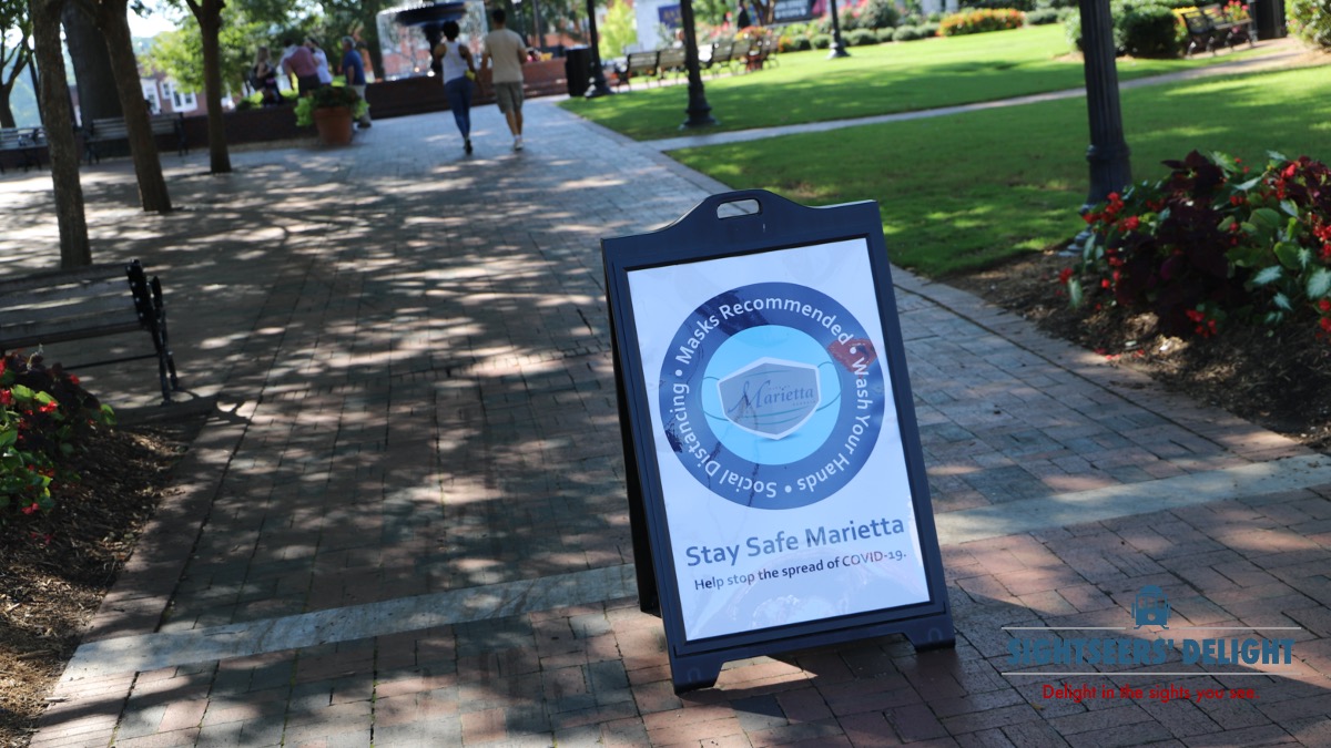 A sign at Glover Park in Marietta, Ga., on Aug. 16, 2020, urges visitors to wear masks and practice social distancing.